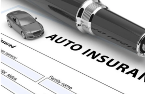 Close-up of an auto insurance form with a pen and a small car model placed on top, symbolizing vehicle coverage and policy documentation